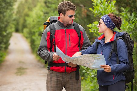 people on trail with map - Fit couple going on a hike together looking at map in the countryside Stock Photo - Budget Royalty-Free & Subscription, Code: 400-07058563