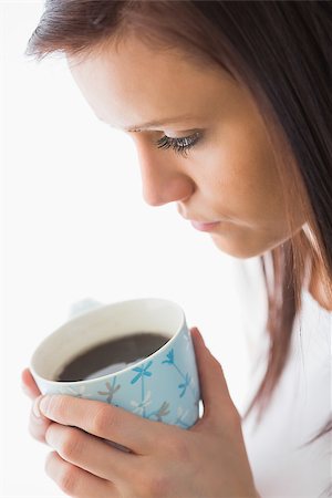 simsearch:400-06932687,k - Peaceful girl holding a cup of coffee on white background Stock Photo - Budget Royalty-Free & Subscription, Code: 400-07059131