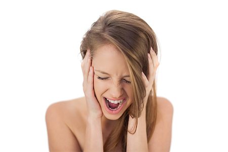 Upset brunette model holding her head and screaming on white background Stock Photo - Budget Royalty-Free & Subscription, Code: 400-07059644