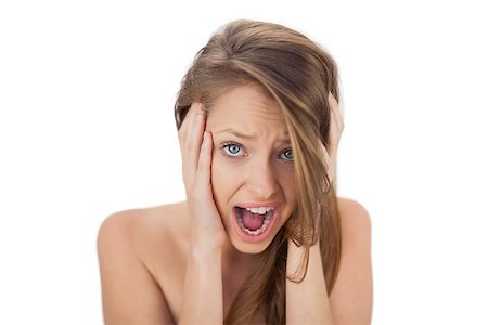 Afraid brunette model holding her head and screaming on white background Photographie de stock - Aubaine LD & Abonnement, Code: 400-07059645