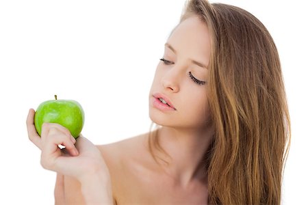 Thoughtful brunette model holding an apple on white background Stock Photo - Budget Royalty-Free & Subscription, Code: 400-07059686