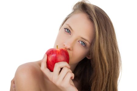 Pensive brunette model eating an apple on white background Stock Photo - Budget Royalty-Free & Subscription, Code: 400-07059692