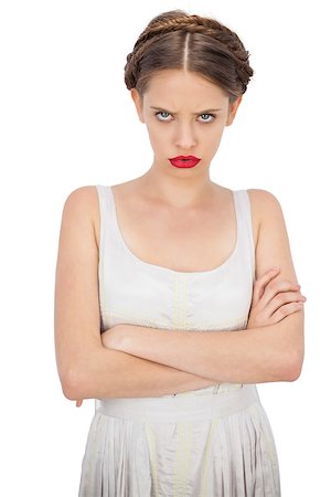 simsearch:400-07059876,k - Frowning model in white dress posing with crossed arms on white background Foto de stock - Super Valor sin royalties y Suscripción, Código: 400-07059888