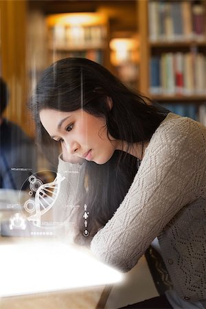 simsearch:400-07138128,k - Student using futuristic hologram to learn about dna from tablet sitting at desk in library Stock Photo - Budget Royalty-Free & Subscription, Code: 400-07059890