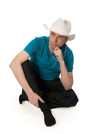 man in a cowboy hat sitting in the lotus position isolated on a white background Foto de stock - Super Valor sin royalties y Suscripción, Código: 400-07050022