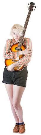 simsearch:400-06561343,k - Timid young European female hugging a guitar Stock Photo - Budget Royalty-Free & Subscription, Code: 400-07050192