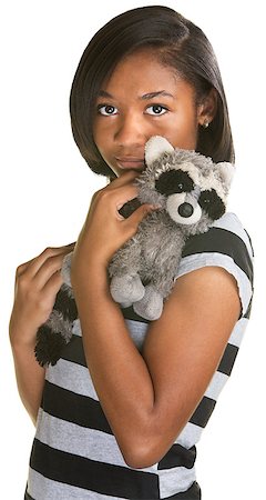 simsearch:400-06426527,k - Sad Hispanic teenage girl holding plush raccoon doll Photographie de stock - Aubaine LD & Abonnement, Code: 400-07050219