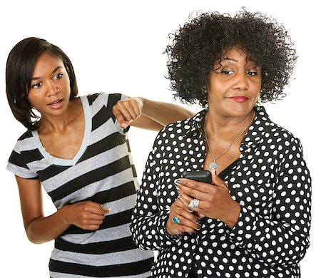 Blushing parent with phone next to nosey teenager Stock Photo - Budget Royalty-Free & Subscription, Code: 400-07050261