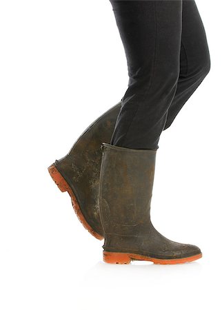 simsearch:400-06700048,k - muddy boots - woman walking with muddy boots on white background Stock Photo - Budget Royalty-Free & Subscription, Code: 400-07050732