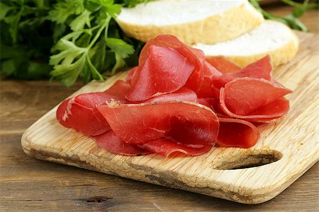 Smoked meat bresaola on a cutting board Stock Photo - Budget Royalty-Free & Subscription, Code: 400-07053803