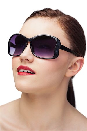 simsearch:400-07059876,k - Cheerful sensual model wearing classy sunglasses on white background Foto de stock - Super Valor sin royalties y Suscripción, Código: 400-07060508