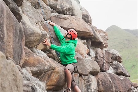 simsearch:400-06956627,k - Fit man scaling a large rock face in the countryside Stock Photo - Budget Royalty-Free & Subscription, Code: 400-07060526