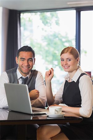 simsearch:400-07137867,k - Business people working together in a cafe smiling at camera Fotografie stock - Microstock e Abbonamento, Codice: 400-07060748