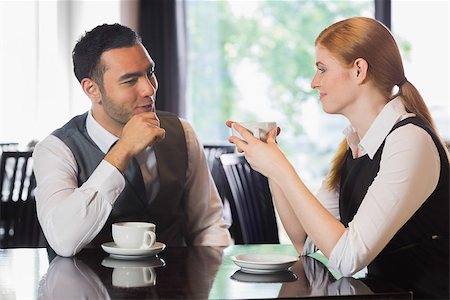 simsearch:400-07137867,k - Business people talking over coffee in a cafe Fotografie stock - Microstock e Abbonamento, Codice: 400-07060761