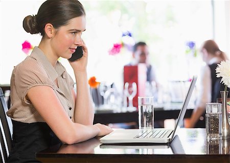 simsearch:400-07137867,k - Businesswoman calling on phone in a restaurant Fotografie stock - Microstock e Abbonamento, Codice: 400-07060818