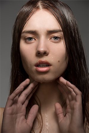 simsearch:400-04001073,k - close-up portrait of beauty clean girl with natural style, wet visage skin and hair. Looking in camera with hands near the face Photographie de stock - Aubaine LD & Abonnement, Code: 400-07061680