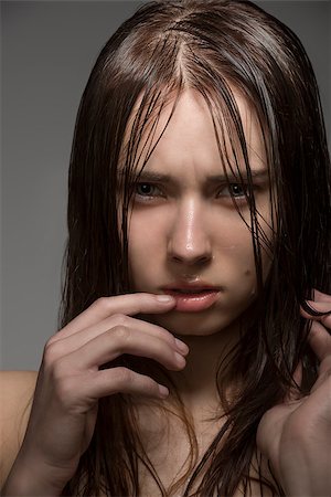 simsearch:400-04001073,k - close-up portrait of young girl with clean skin, long wet hair and some water drops on the face. Looking in camera with angry expression Photographie de stock - Aubaine LD & Abonnement, Code: 400-07061681