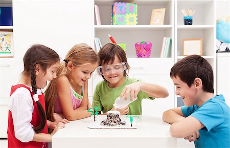 Kids repeating and observing a science lab project at home - the baking soda and vinegar volcano Fotografie stock - Microstock e Abbonamento, Codice: 400-07086793