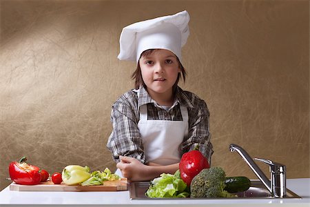 Young boy wearing a chef hat washing vegetables for a salad - copy space Stock Photo - Budget Royalty-Free & Subscription, Code: 400-07086813