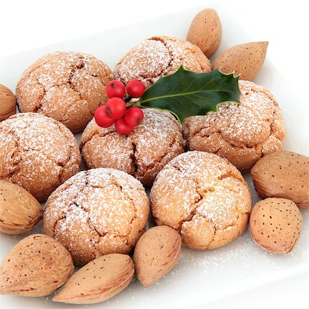 Amaretti biscuits with almond nuts and holly berry leaf sprig over white background. Stock Photo - Budget Royalty-Free & Subscription, Code: 400-07086867