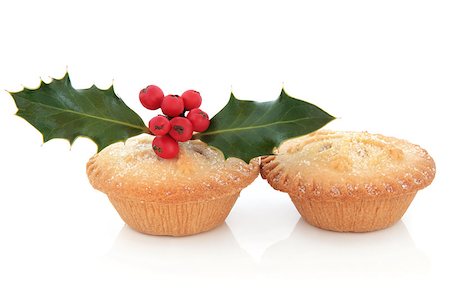 Mince pie cakes with snowflake design, holly and red berry leaf sprig over white background Stock Photo - Budget Royalty-Free & Subscription, Code: 400-07086984