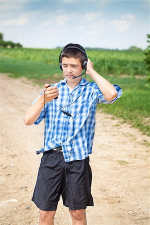 Boy with headphones and Mic on rural road Stock Photo - Budget Royalty-Free & Subscription, Code: 400-07087077