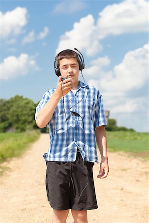 Boy with headphones and Mic on rural road in summer Stock Photo - Budget Royalty-Free & Subscription, Code: 400-07087085