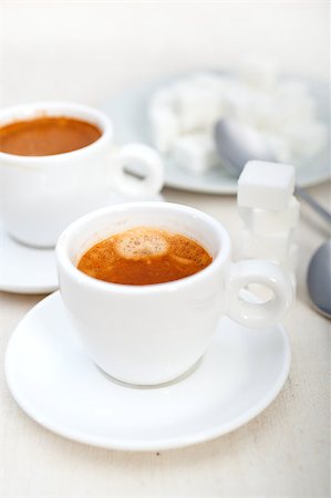 simsearch:400-04643797,k - Italian espresso coffee fresh brewed macro closeup with sugar cubes Photographie de stock - Aubaine LD & Abonnement, Code: 400-07088158