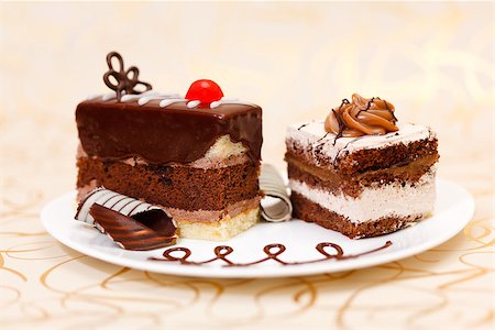 Two chocolate cakes on plate on golden background Stock Photo - Budget Royalty-Free & Subscription, Code: 400-07088672