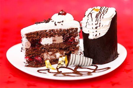 Two slice chocolate fancy cake on red background Stock Photo - Budget Royalty-Free & Subscription, Code: 400-07088681