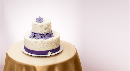 White wedding cake with violet marzipan flower decoration. Copy space on right Stock Photo - Budget Royalty-Free & Subscription, Code: 400-07088692