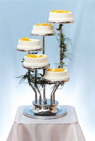 Multi-storey white wedding cake with fruits on blue background Stock Photo - Budget Royalty-Free & Subscription, Code: 400-07088719