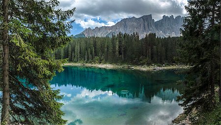 Carezza lake and Latemar in summer season with clouds, Dolomites - Italy Stockbilder - Microstock & Abonnement, Bildnummer: 400-07089612