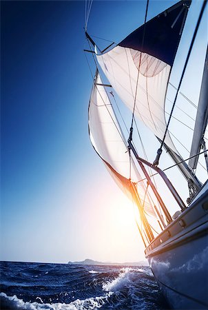 sailboat racing - Sail boat in action, summer adventure, luxury water transport, sunset light, active lifestyle, recreation in the sea, travel and tourism concept Stock Photo - Budget Royalty-Free & Subscription, Code: 400-07094015