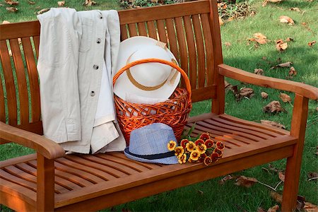 A bench on the grass on the bench white jacket men's and women's hats basket and bunch of flowers Stock Photo - Budget Royalty-Free & Subscription, Code: 400-07094276