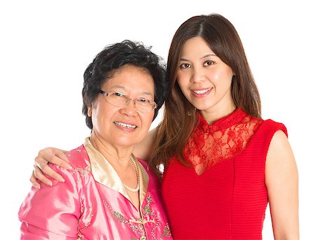simsearch:400-04400433,k - Chinese New Year festival. Happy Asian Chinese senior mother and adult daughter standing isolated on white background Stock Photo - Budget Royalty-Free & Subscription, Code: 400-07094830