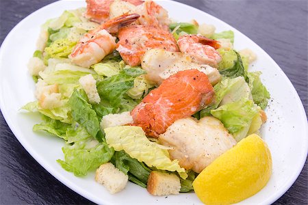 Caesar Salad with Prawns Salmon White Cod Fish Croutons Lemon and Cracked Black Pepper Stock Photo - Budget Royalty-Free & Subscription, Code: 400-07095328