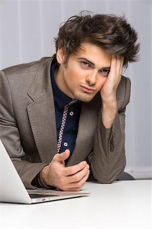 simsearch:400-04591983,k - Stressed young businessman showing an attitude of failure, disappointment at work. Banking, insurance, law, sales. Fotografie stock - Microstock e Abbonamento, Codice: 400-07096095