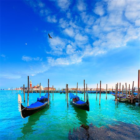 simsearch:400-06391540,k - Venice. Gondolas. Canale della Giudecca. San Giorgio Maggiore. Venice is a city in northeast Italy which is renowned for the beauty of its setting, its architecture and its artworks. It is the capital of the Veneto region. Stock Photo - Budget Royalty-Free & Subscription, Code: 400-07096636