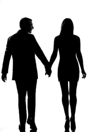 rear view one lovers caucasian couple man and woman walking hand in hand in studio silhouette isolated on white background Stock Photo - Budget Royalty-Free & Subscription, Code: 400-07097694