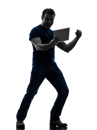 people ipad computer studio - one caucasian man holding watching digital tablet   in silhouette on white background Stock Photo - Budget Royalty-Free & Subscription, Code: 400-07097792