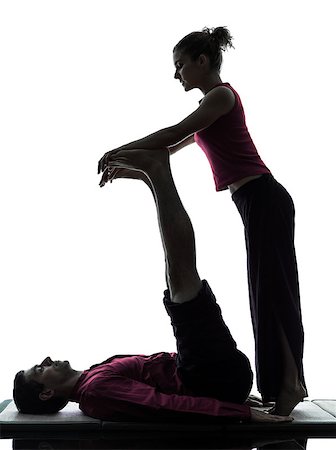 full body massage - one man and woman performing feet legs thai massage in silhouette studio on white background Foto de stock - Super Valor sin royalties y Suscripción, Código: 400-07097826