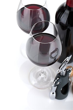 simsearch:400-06796159,k - Red wine, corks and corkscrew. Isolated on white background, closeup, focus on glasses. Stock Photo - Budget Royalty-Free & Subscription, Code: 400-07098463