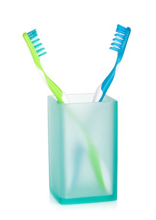 Two multicolored toothbrushes in glass. Isolated on white background Stock Photo - Budget Royalty-Free & Subscription, Code: 400-07098505