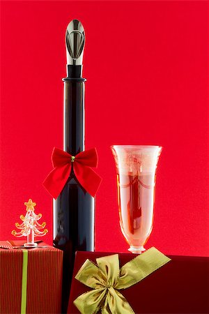 simsearch:400-05307881,k - Bottle decorated with a Christmas bowknot a glass of wine and boxes with gifts Stock Photo - Budget Royalty-Free & Subscription, Code: 400-07098716
