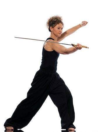 mature woman praticing tai chi chuan with sword in studio on isolated white background Stock Photo - Budget Royalty-Free & Subscription, Code: 400-07098786