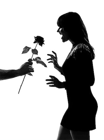 simsearch:400-07097695,k - man hand offering a flower rose stylish sexy silhouette caucasian beautiful woman on studio isolated white background Stock Photo - Budget Royalty-Free & Subscription, Code: 400-07098824