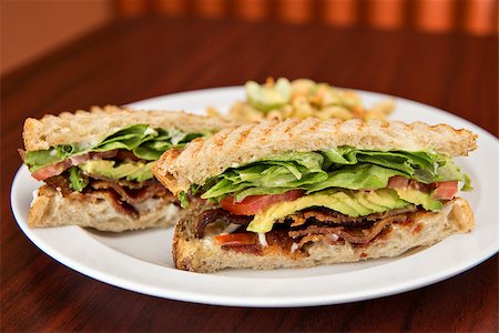 sandwich with avocado - A deli classic bacon lettuce and tomato sandwich with avocado on whole wheat bread. Stock Photo - Budget Royalty-Free & Subscription, Code: 400-07099474