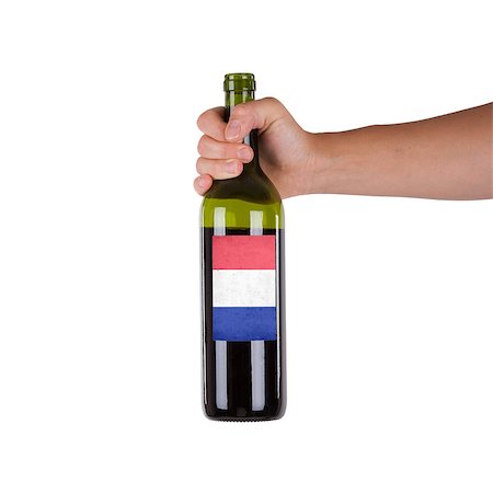 france cellar - Hand holding a bottle of red wine, label of France, isolated on white, Stock Photo - Budget Royalty-Free & Subscription, Code: 400-07099528