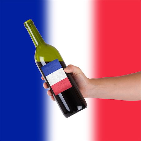 france cellar - Hand holding a bottle of red wine, label of France, isolated on white, Stock Photo - Budget Royalty-Free & Subscription, Code: 400-07099535
